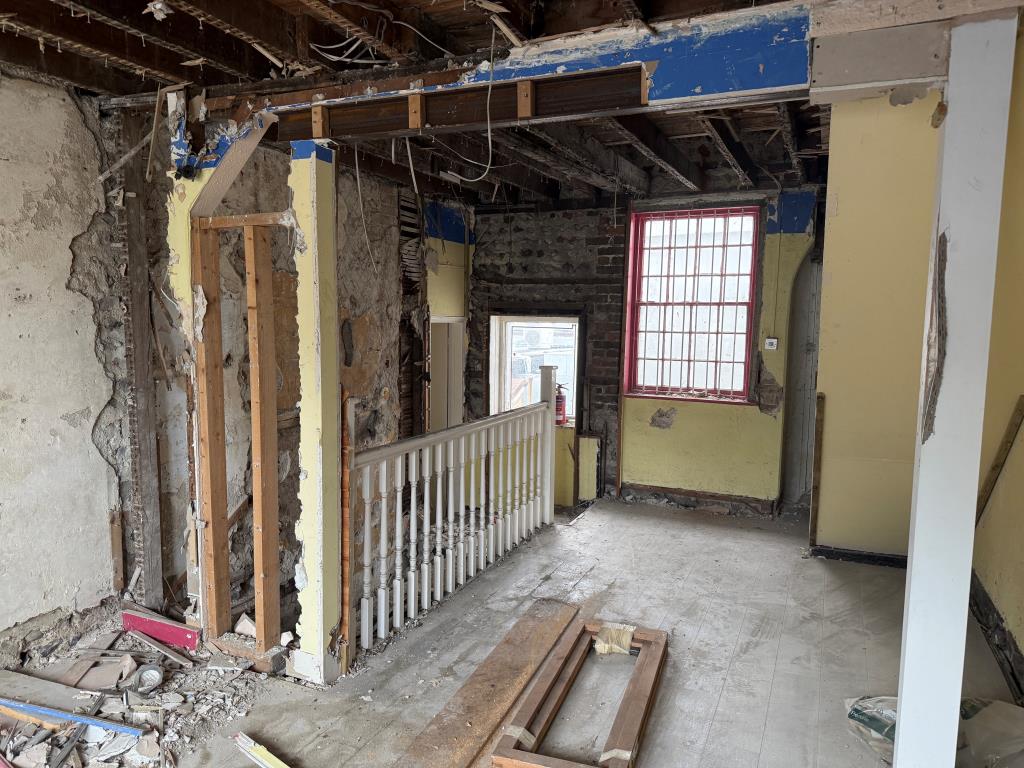 Lot: 52 - FREEHOLD SHOP AND UPPER PARTS IN NEED OF COMPLETE REFURBISHMENT - Rear of first floor with window and staircase